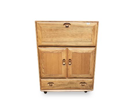 An Ercol light elm bureau or writing cabinet, with all front above two doors and a basal drawer, height 110cm, width 82cm, de