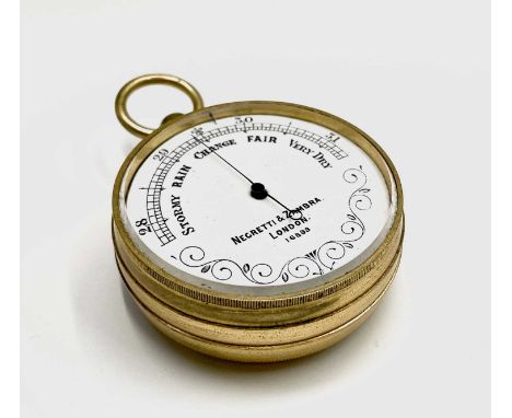 A Negretti &amp; Zambra gilt cased aneroid barometer, the white enamel dial numbered 16899, circa 1900, diameter 4.8cm.Condit