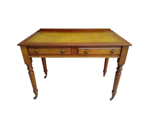 An Arts &amp; Crafts mahogany writing table, with a rectangular leather inset top, above two drawers stamped 'Maple London', 