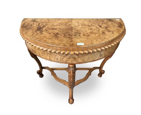 A Regency style walnut demi lune card table, with acanthus leaf carved cabriole legs. Height 76cm, width 88cm, depth 48cm.