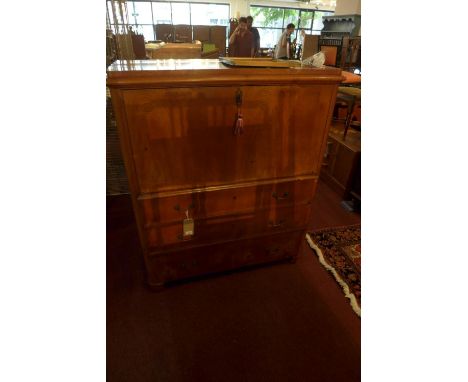 A late 19th century Biedermeier pine escretaire, with drop flap, enclosing fully fitted interior, above three drawers, raised