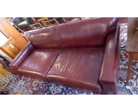 A contemporary brown leather three seater sofa 