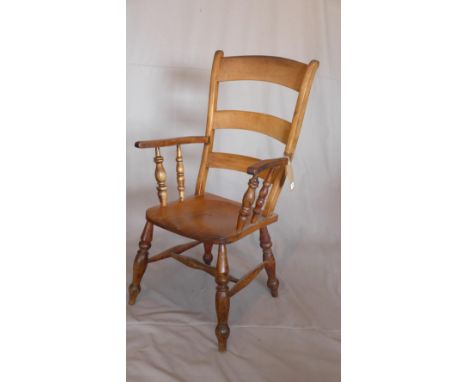 A late 19th century oak ladder back armchair 