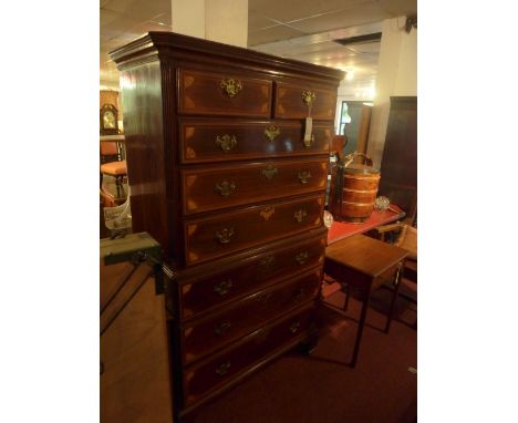 A late 19th century Sheraton revival mahogany chest on chest, with eight drawers, having marquetry inlay, raised on bracket f