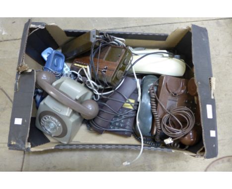 A box of assorted vintage telephones