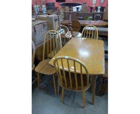 An Ercol style drop-leaf table and four chairs