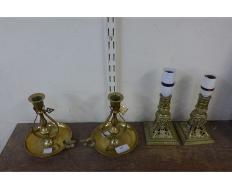 A pair of brass gimble ship's candlesticks and a pair of converted table lamp bases