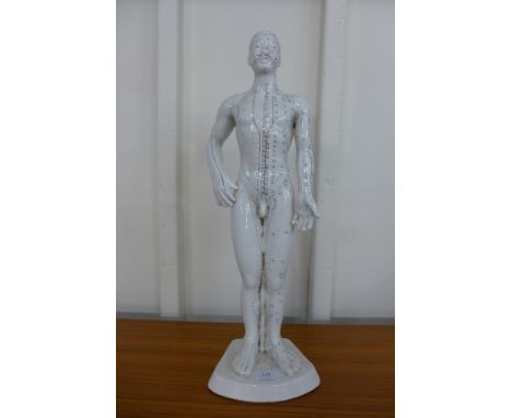 A ceramic male acupuncture model