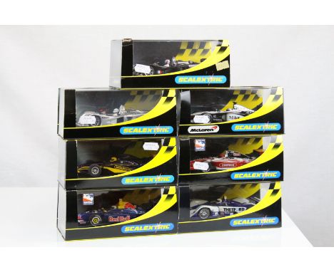 Seven cased Scalextric slot cars to include ltd edn C2394 Dallara Indy Red Bull No 52, C2262 McLaren Mercedes F1 MP4-16 No3, 