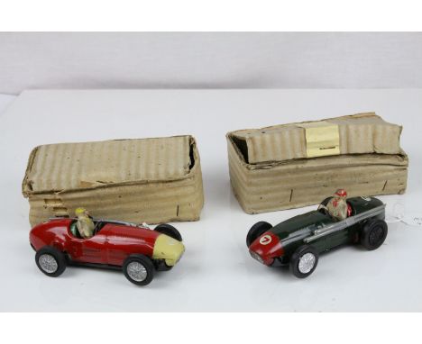 Two early tin plate Scalextric racing slot cars both with drivers, one red (driver missing one arm) and green, in cardboard b