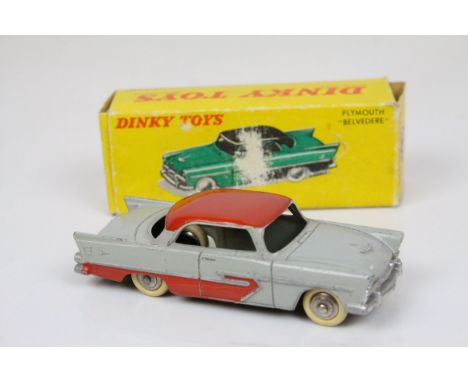 Boxed French Dinky 24D Plymouth Belvedere diecast model with grey body and red roof, cream tyres, box showing wear