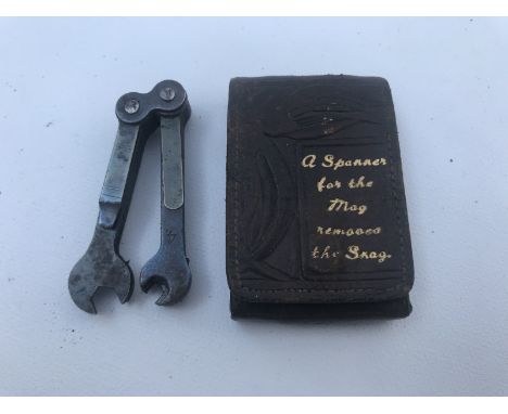 A leather cased set of miniature spanners, the lid bearing the words 'A spanner for the mag removes the snag'.