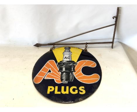 An AC Plugs circular double sided pictorial enamel sign on hanging bracket, 18" diameter (measurement for sign only).