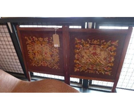 An early 20th century mahogany fire screen decorated with needlework tapestry depicting floral cartouche, H.78cm, together wi