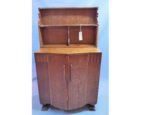 An Art Deco oak Ercol cabinet, with superstructure over two doors, enclosing drawer and shelf space, with original label, H.1