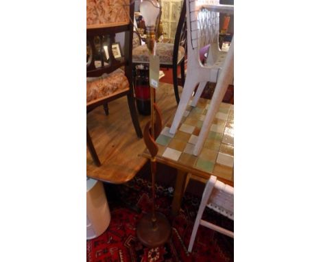 A mid 20th century teak and brass standard lamp 