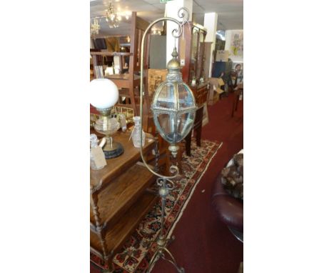 A gilt metal hanging lantern, raised a gilt metal stand with a quadripartite base and scroll feet, H.163cm 