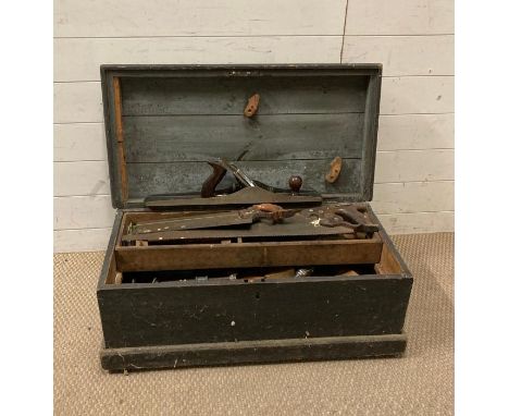 A large vintage wooden tool box containing hand saws, planes etc 