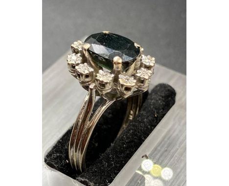 An emerald and diamond ring set in and 18ct white gold setting. (Size O)