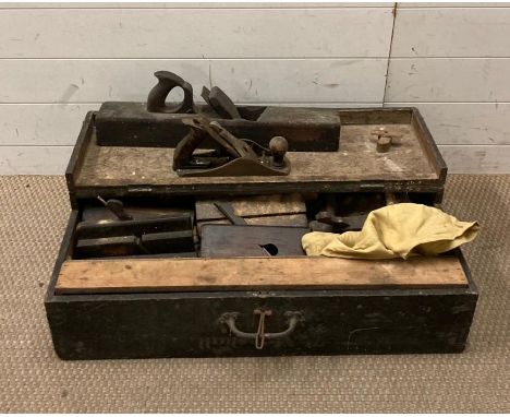 A large wooden tool box containing a selection of vintage tools 