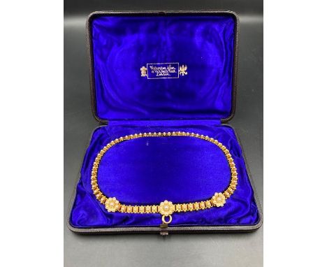 A Victorian Pinchbeck and pearl necklace in purple silk lined box from Watherston &amp; Son 12 Pall Mall East London.