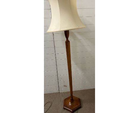 A standard lamp with trophy style detail on an octagonal shape pole and base possibly Heals 