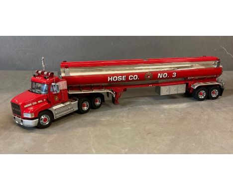 A Franklin Mint Diecast model of a Mack Tractor and Hose Co Trailer 