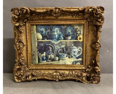 A gilt framed printed tile of blue and white ceramics 