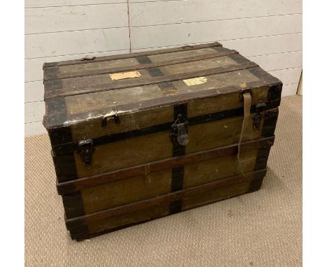 A vintage wooden and metal banded steamer trunk 