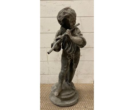 A lead garden figure of a young boy playing the flute 