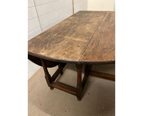 A drop leaf gate leg oak table (H70cm W152cm D136cm)