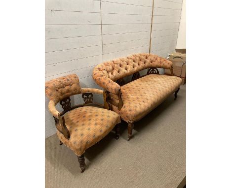 A Victorian mahogany button back arm chair and sofa on castors 