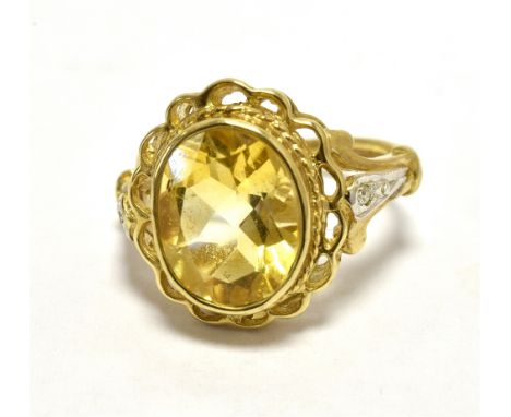 GOLD CITRINE COCKTAIL RING 9CT The Oval faceted citrine measuring 9 x 8mm approx and flanked each side with a tiny diamond to