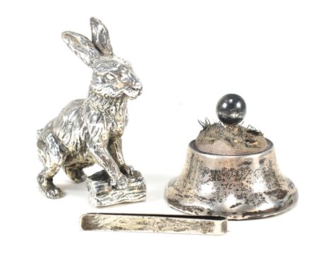 A hallmarked silver pin cushion with baize top. Hallmarked Chester 1914, sponsors mark illegible. Together with a silver tie 