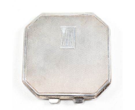 A 1940s hallmarked silver compact. The compact having an engine turned decorated case opening to reveal a mirror and powder p