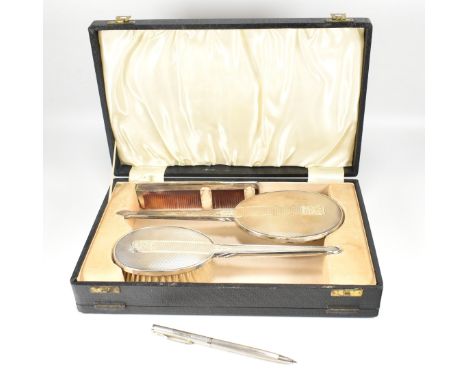 Hallmarked silver cased dressing table set. Comprising brush, mirror and comb. Hallmarked Birmingham 1940, sponsors mark for 