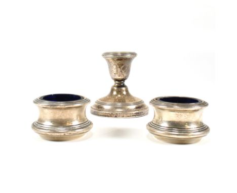 A pair of George V hallmarked silver table salts. The salts, each with blue glass liners. Hallmarked Birmingham 1945, sponsor