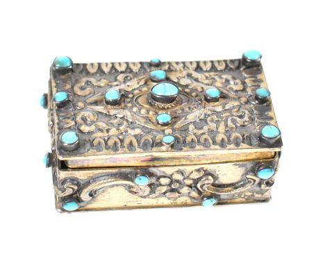 Asian silver and turquoise set pill / snuff box. Rectangular form, cast in repousse and set with turquoise cabochons with hin