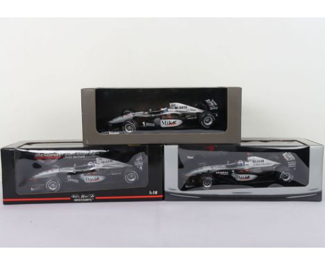 Three McLaren Collection Formula One 1:18 Scale Model Cars. Including David Coulthard, Mika.  Brand new in box. (3 items)