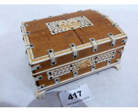 A 19th century ivory mounted trinket box, the lid interior with a mirror. 5' wide