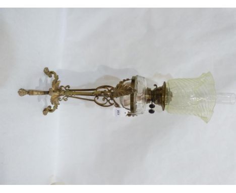 A fine Victorian gilt brass oil lamp, with duplex burner, clear glass fount and vaseline shade, the base wrought with scrolls