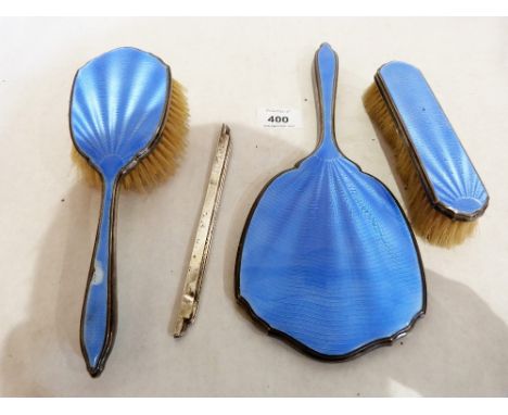 A George V silver and blue guilloche enamel three piece dressing table set, Birmingham 1934, the lot to include a silver comb