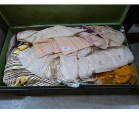 A tin trunk of miscellaneous textiles