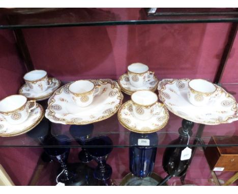 A 19th century part tea service, gilded and painted with flower sprays. 17 pieces