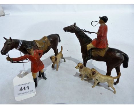 A pair of early 20th century cold painted lead hunting groups. 4' and 5' high