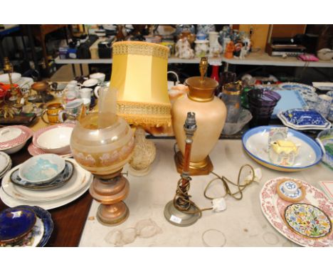 A paraffin lamp and shade with three other table lamps