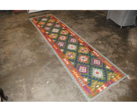 An approx. 10'3" x 2'9" Kelim runner 
