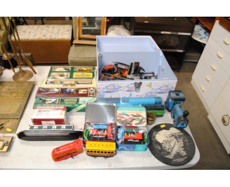 A quantity of various railway items to include a Brimtoy model of a train, a wall plaque, die-cast vehicles etc. 