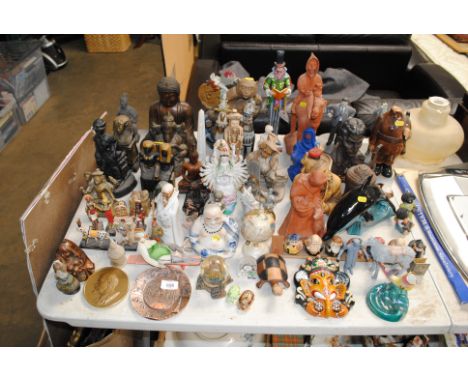 A quantity of various ornaments and figurines to include Poole Pottery dolphin; Buddhas etc. 