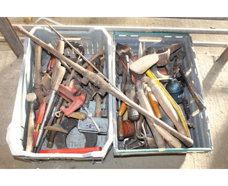 Two boxes containing various tools to include shears; pickaxe head; hammer; hand brace; mallet; oil can etc.